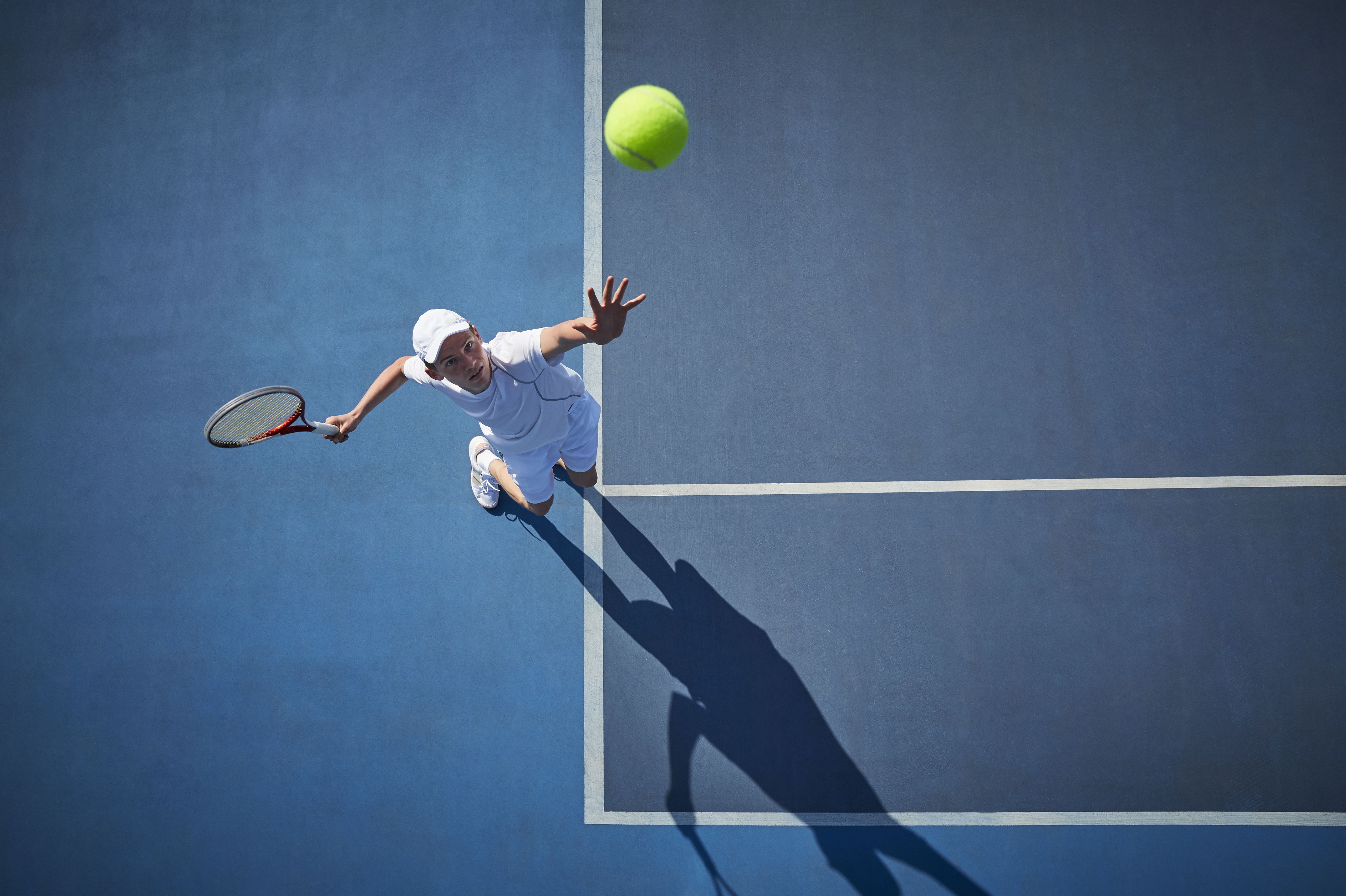 Overhead view of male ennis player serving